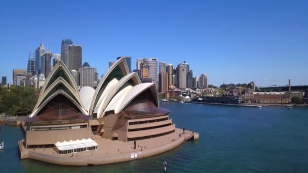 Sydney opera house aerial shot over the bay with the sydney skyline behind it sydney australia — Stock video