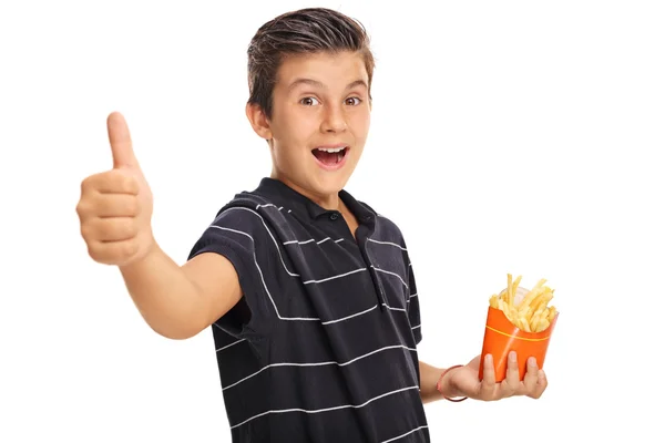 Niño dando un pulgar hacia arriba y sosteniendo una bolsa de papas fritas — Foto de Stock