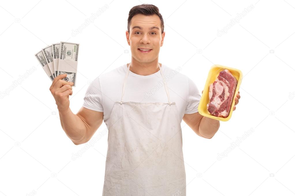 Butcher holding a steak and stacks of money