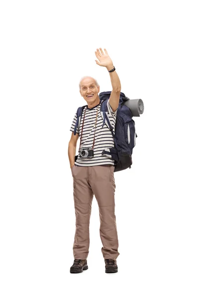 Mature male hiker waving at the camera — Stock Photo, Image