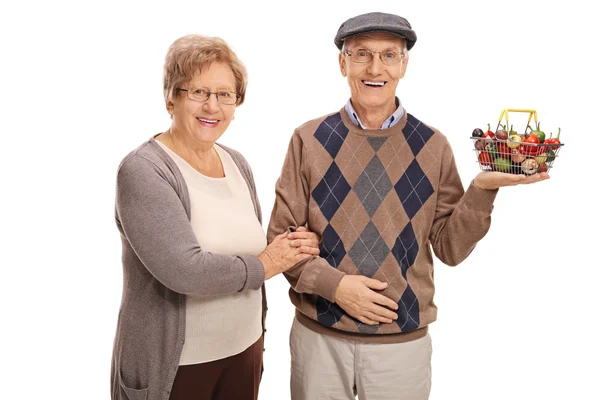 Mature couple posing with a small shopping basket — Stock Photo, Image