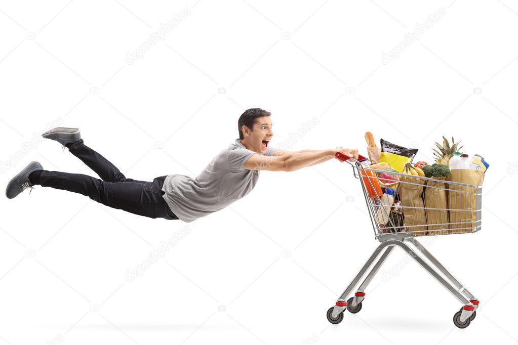 Man being pulled by a shopping cart full of groceries