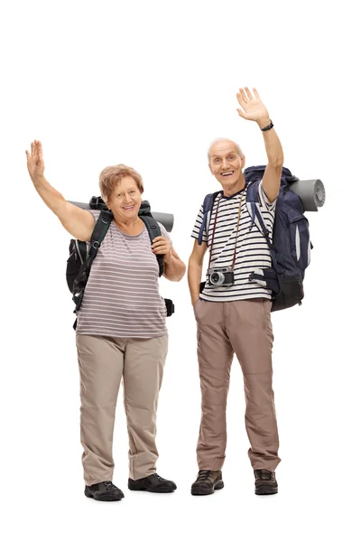 Two senior hikers waving at the camera — Stock Photo, Image