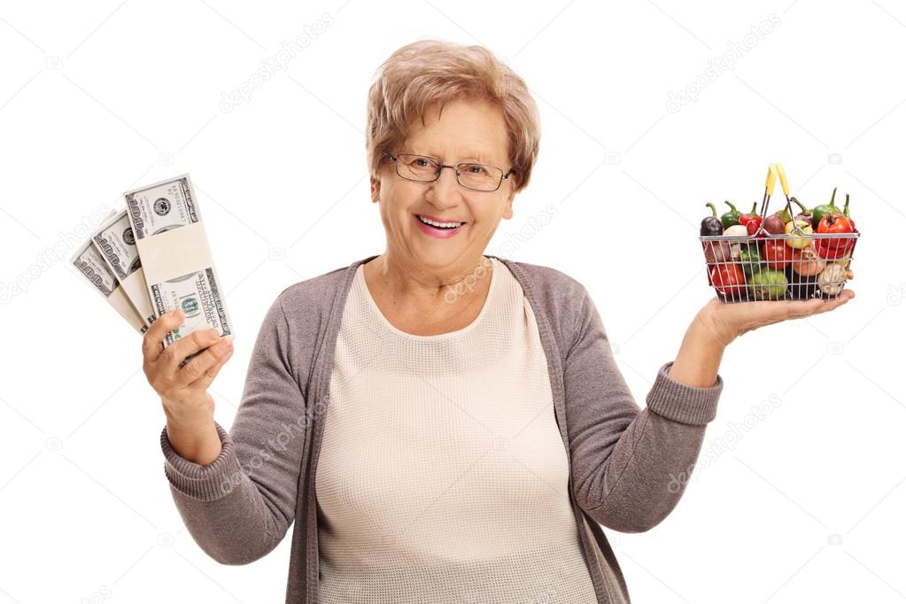 Woman holding a shopping basket and money stacks
