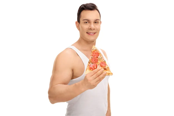 Jovem com uma fatia de pizza — Fotografia de Stock