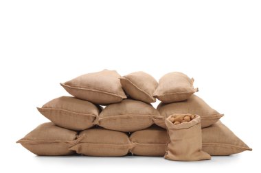 Pile of burlap sacks filled with potatoes clipart