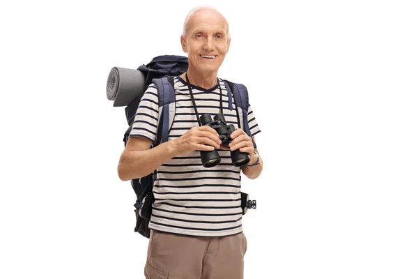 Mature hiker holding a binoculars — Stock Photo, Image