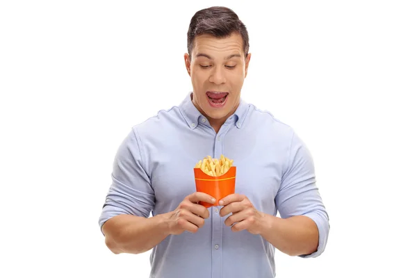Overjoyed man looking at a bag of fries — Stock fotografie