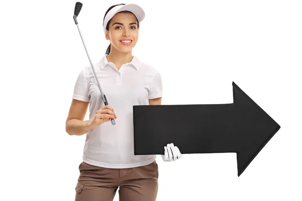 Female golf player holding golf club and arrow — Stockfoto