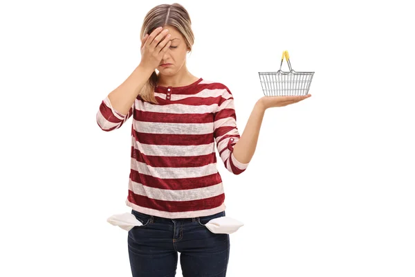 Woman with empty pockets holding her head in disbelief — Stock Photo, Image