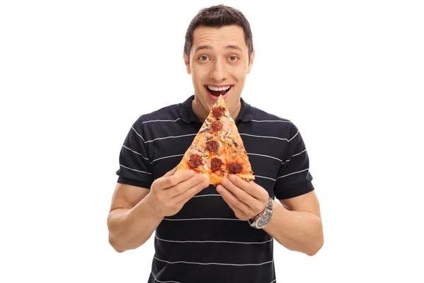 Chico alegre comiendo una rebanada de pizza — Foto de Stock