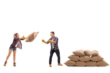 Kadın çiftçi bir çuval çuval bir erkek çiftçi atma.