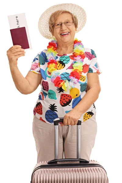 Elderly tourist holding a passport and a suitcase — Stock Photo, Image