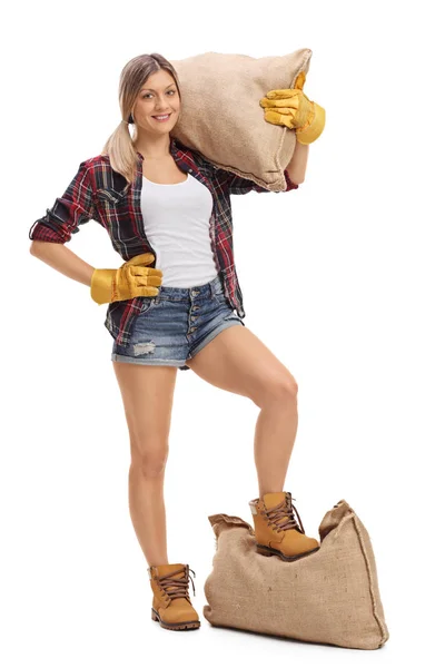 Female agricultural worker with burlap sacks — Stock Photo, Image