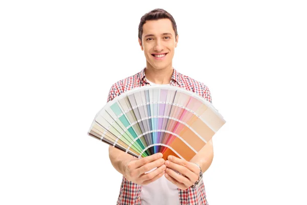 Happy young man holding a color swatch Royalty Free Stock Images