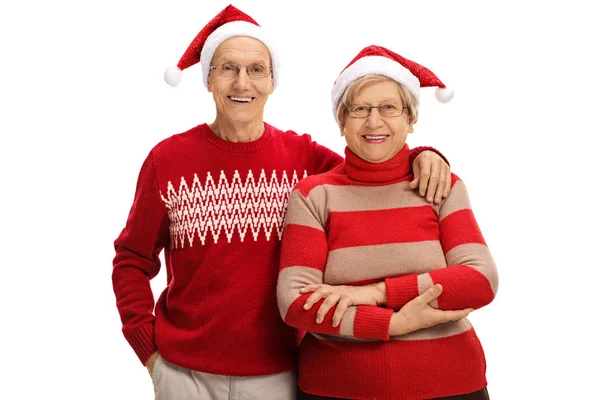 Anziani con Babbo Natale cappelli guardando la fotocamera — Foto Stock
