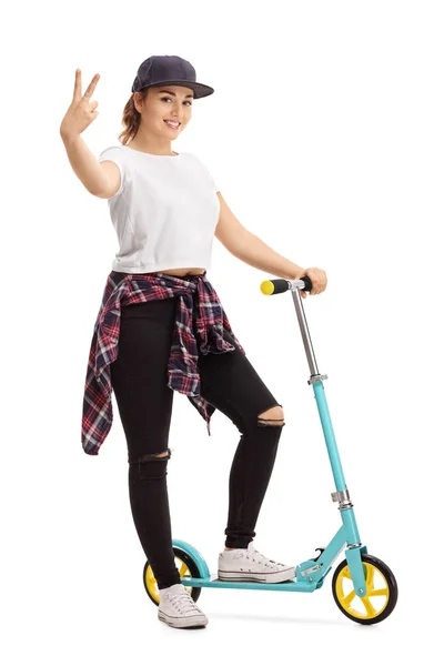 Woman with a scooter making a peace sign — Stock Photo, Image