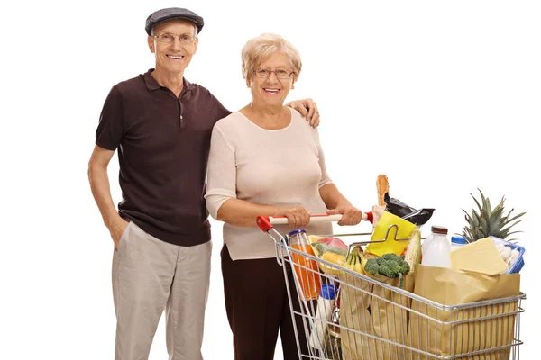 Senioren met een winkelen winkelwagen vol boodschappen — Stockfoto