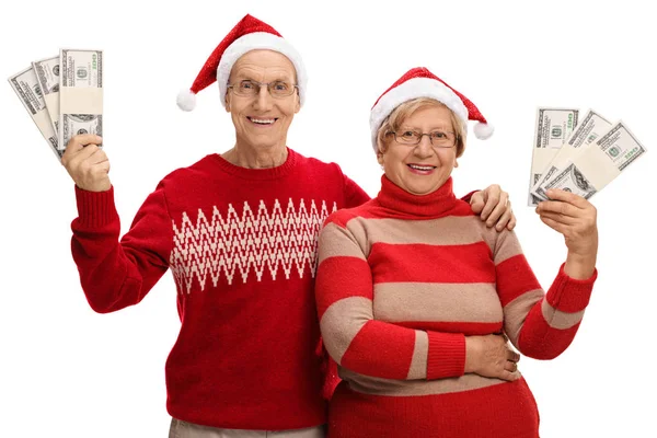 Senioren met Kerstmis hoeden en geld bundels — Stockfoto