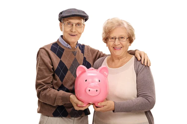 Glada seniorer med en piggybank — Stockfoto
