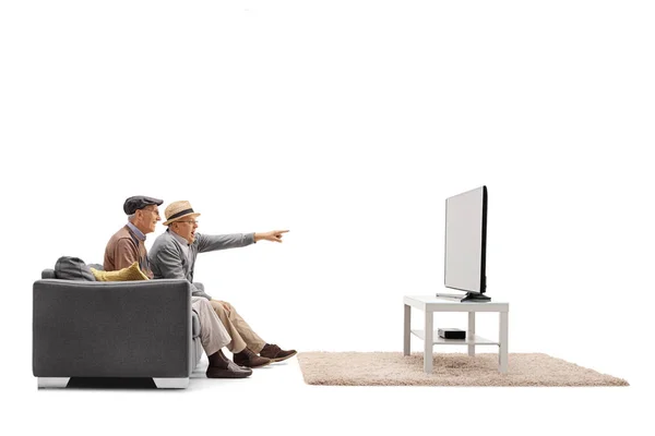 Uomini maturi su un divano e guardando la televisione — Foto Stock