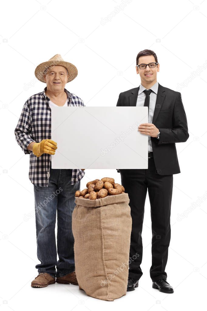 Farmer and a businessman holding a blank cardboard sign