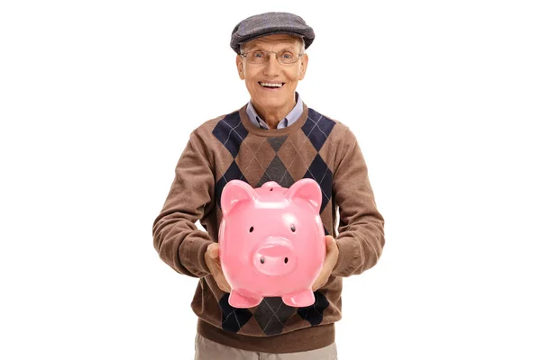 Happy elderly man giving a piggybank — Stock Photo, Image