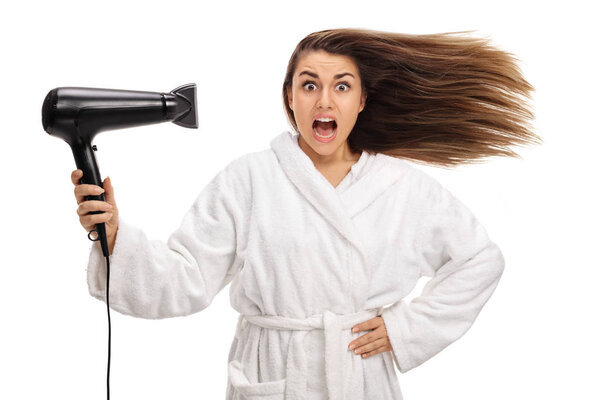 Shocked woman drying her hair with a hairdryer