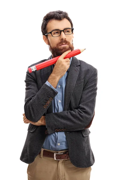 Pensive guy holding a big pencil — Stock Photo, Image