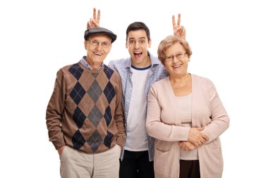 man pranking a mature man and woman with bunny ears clipart