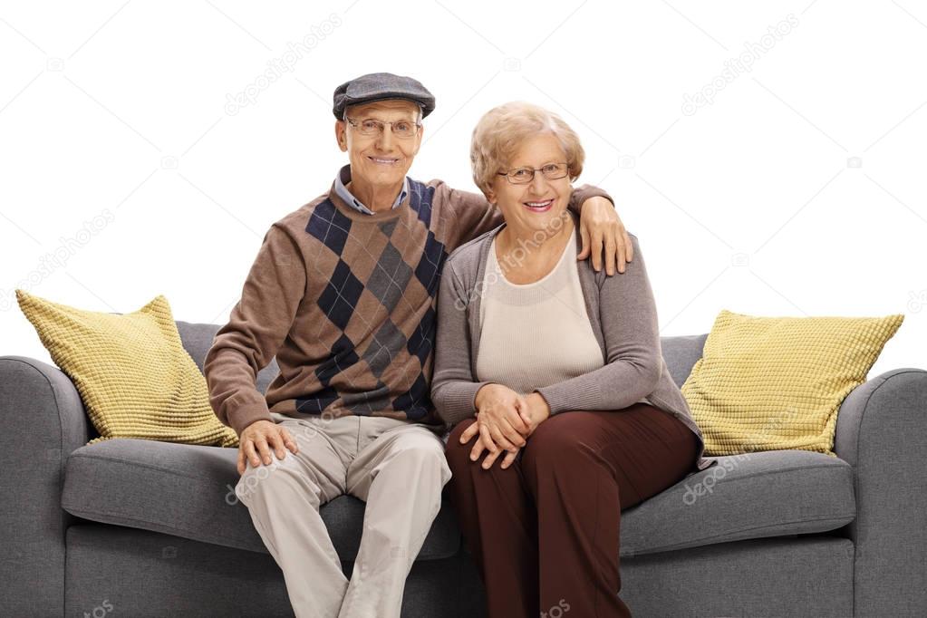 senior couple posing together on a sofa