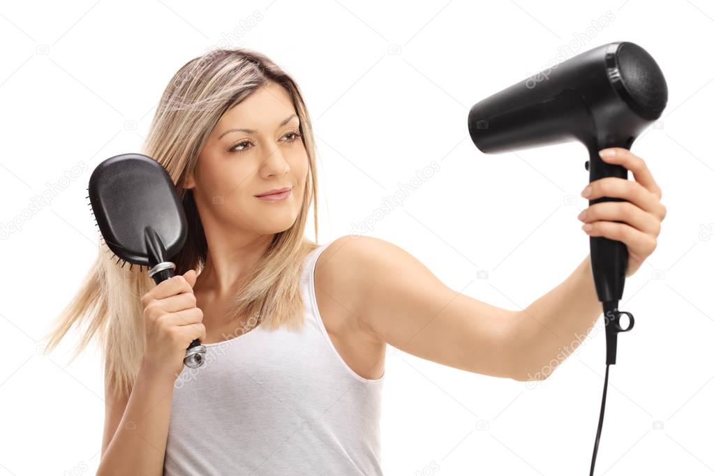 Woman blow drying her hair