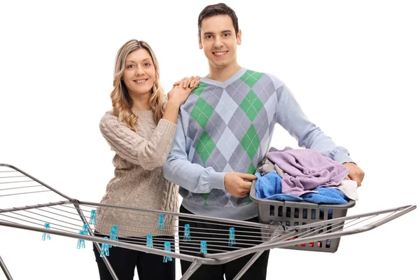 Couple behind a clothing rack dryer — Stock Photo, Image