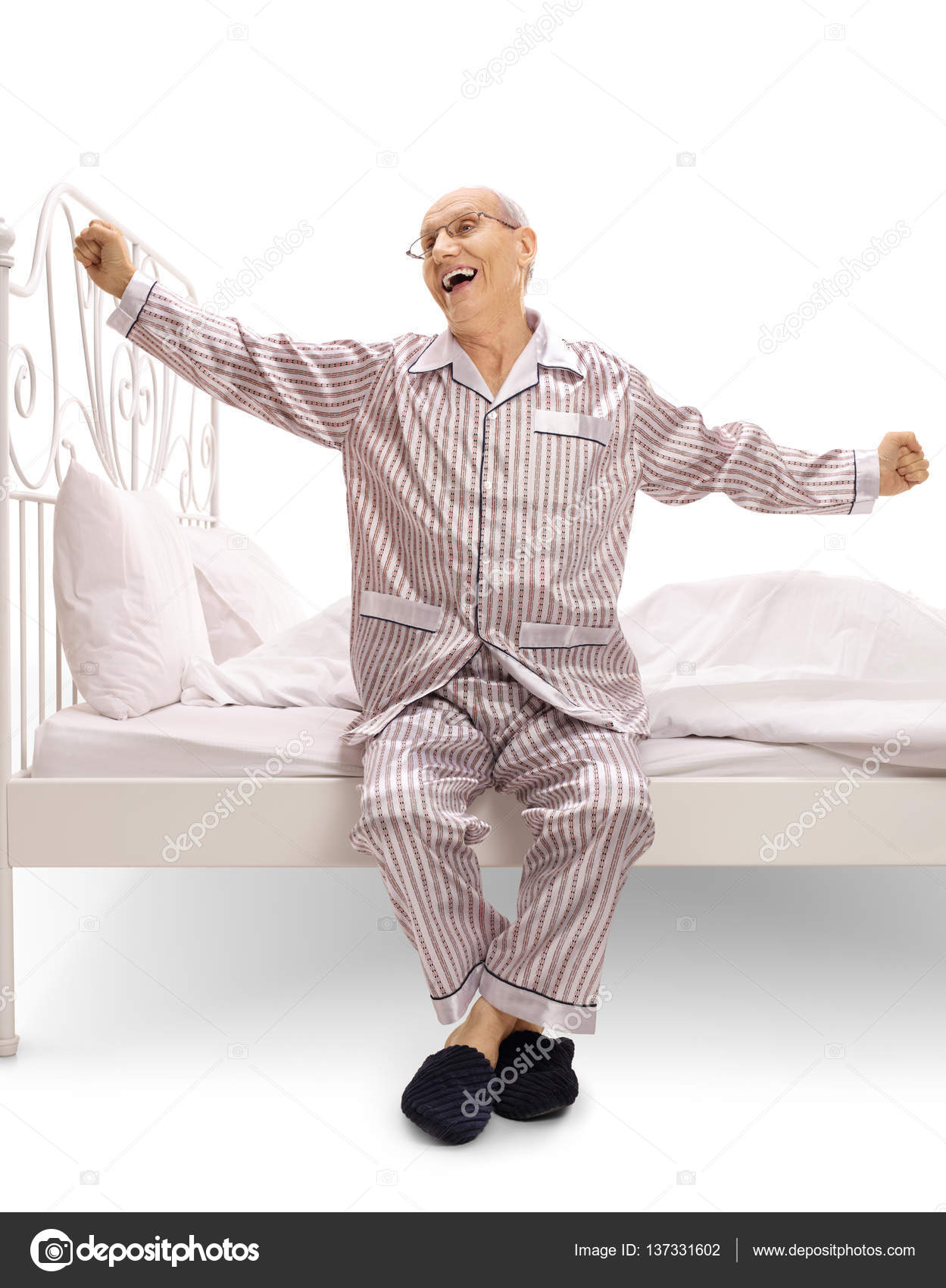 Elderly man in pajamas sitting on a bed and yawning Stock Photo ljsphotography 137331602