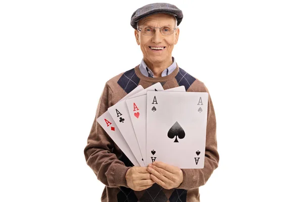 Cheerful mature man holding four aces — Stock Photo, Image
