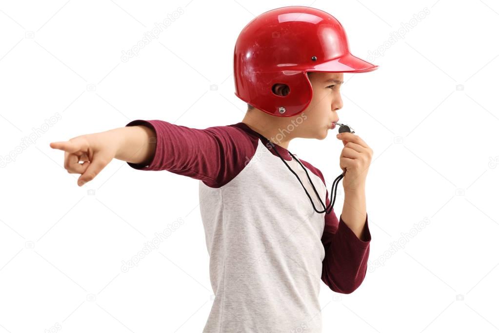 Boy blowing whistle and pointing with his hand