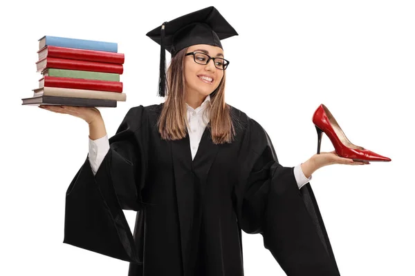 Student hält Stapel von Büchern und Schuhen in der Hand — Stockfoto