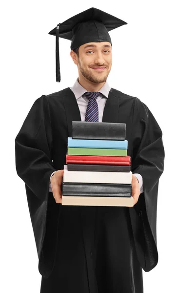 Estudante de pós-graduação masculino segurando uma pilha de livros — Fotografia de Stock