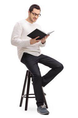 Man sitting on a chair and reading a book clipart