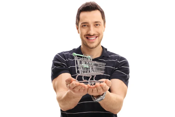 guy holding a small empty shopping cart