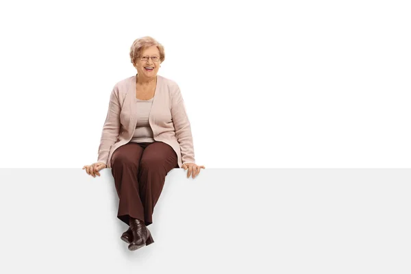 Радостная зрелая женщина сидит на панели — стоковое фото