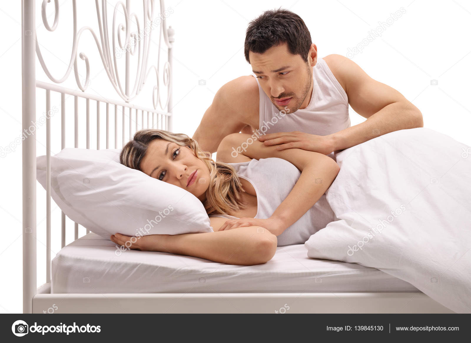 Unhappy woman in bed with concerned guy comforting her Stock Photo by ©ljsphotography 139845130