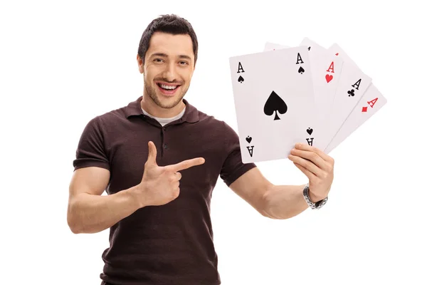 Happy guy holding four aces and pointing — Stock Photo, Image