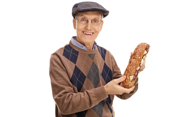 Happy senior holding a sandwich — Stock Photo, Image
