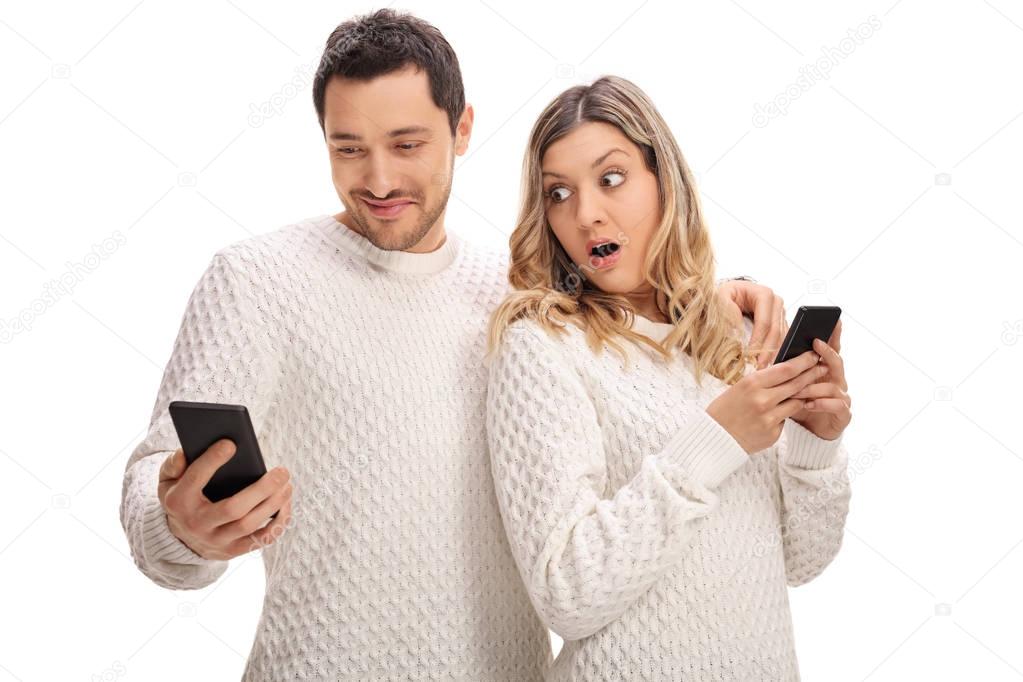 Upset woman looking at her boyfriends phone 