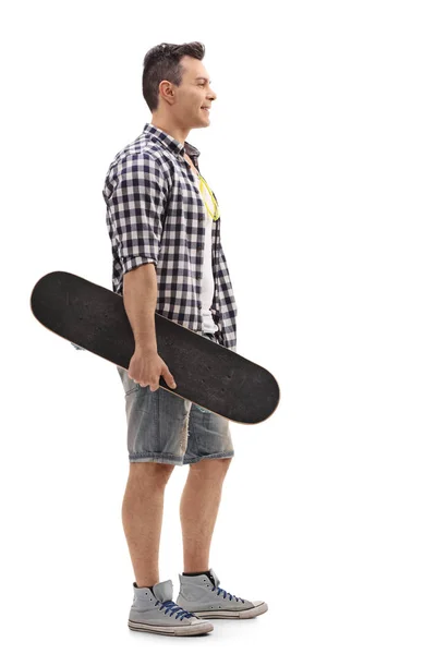 Skater holding a skateboard and waiting in line — Stock Photo, Image