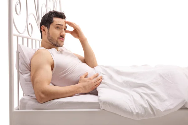 Worried guy lying in bed — Stock Photo, Image