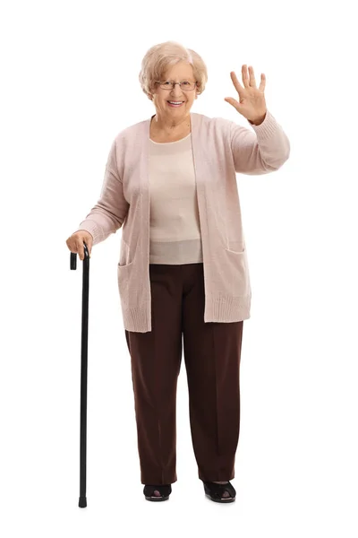 Femme âgée avec une canne à pied agitant — Photo