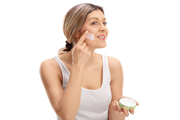 Mujer bonita aplicando crema para la piel en su cara —  Fotos de Stock