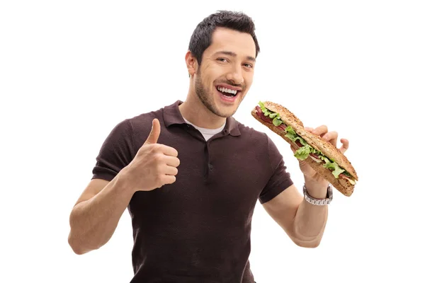 Man having sandwich and making thumb up gesture — Stock Photo, Image